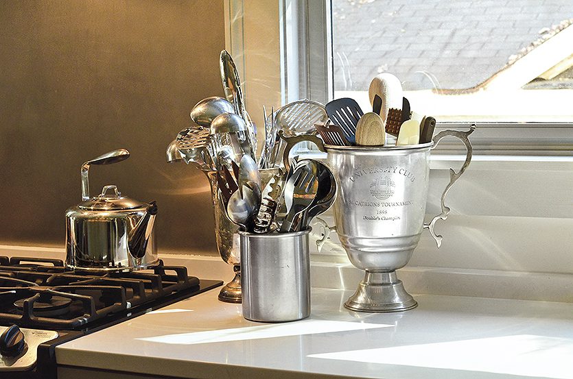 Silver urns to hold cookware on countertop