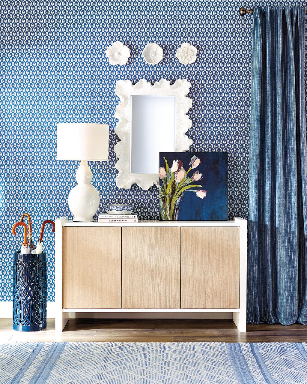 A pretty white mirror and console table create a entryway with form and function