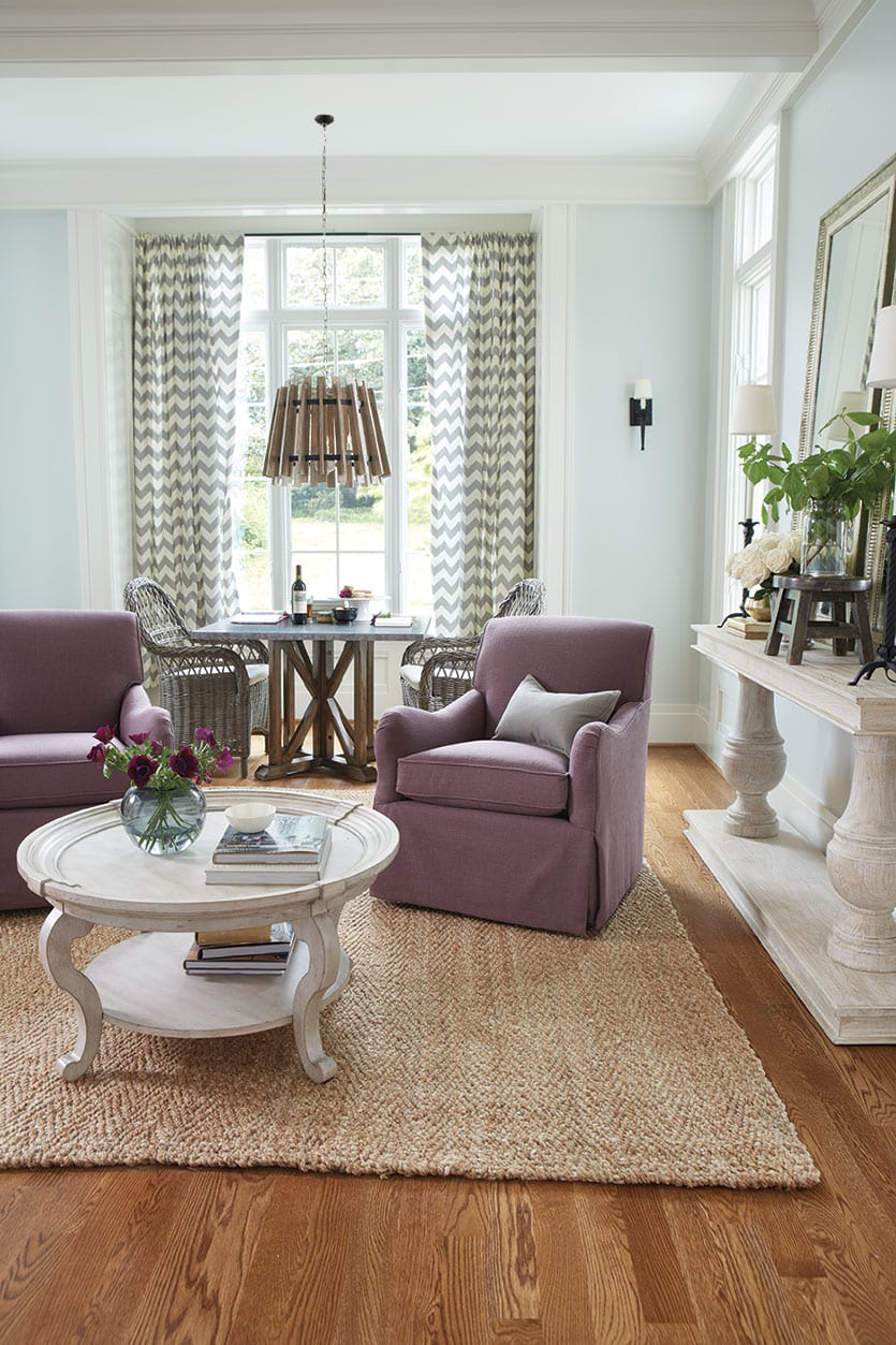 A pair of purple linen armchairs gives this space a polished, bold feel