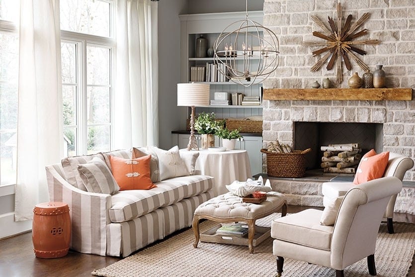 Living room with striped sofa and coral accents