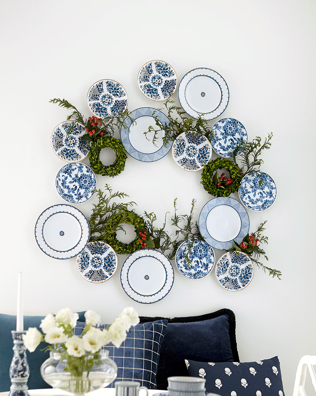 Christmas wreaths and plates hung together