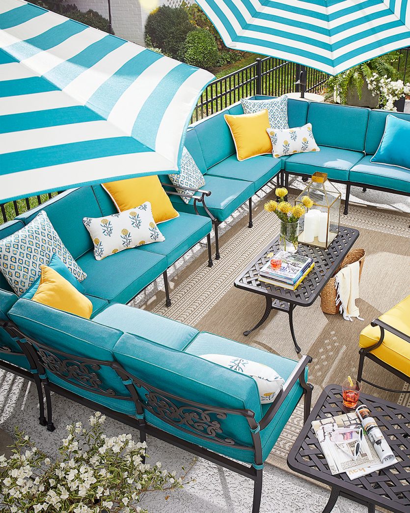 Yellow and teal cushions on Ballard Designs outdoor furniture