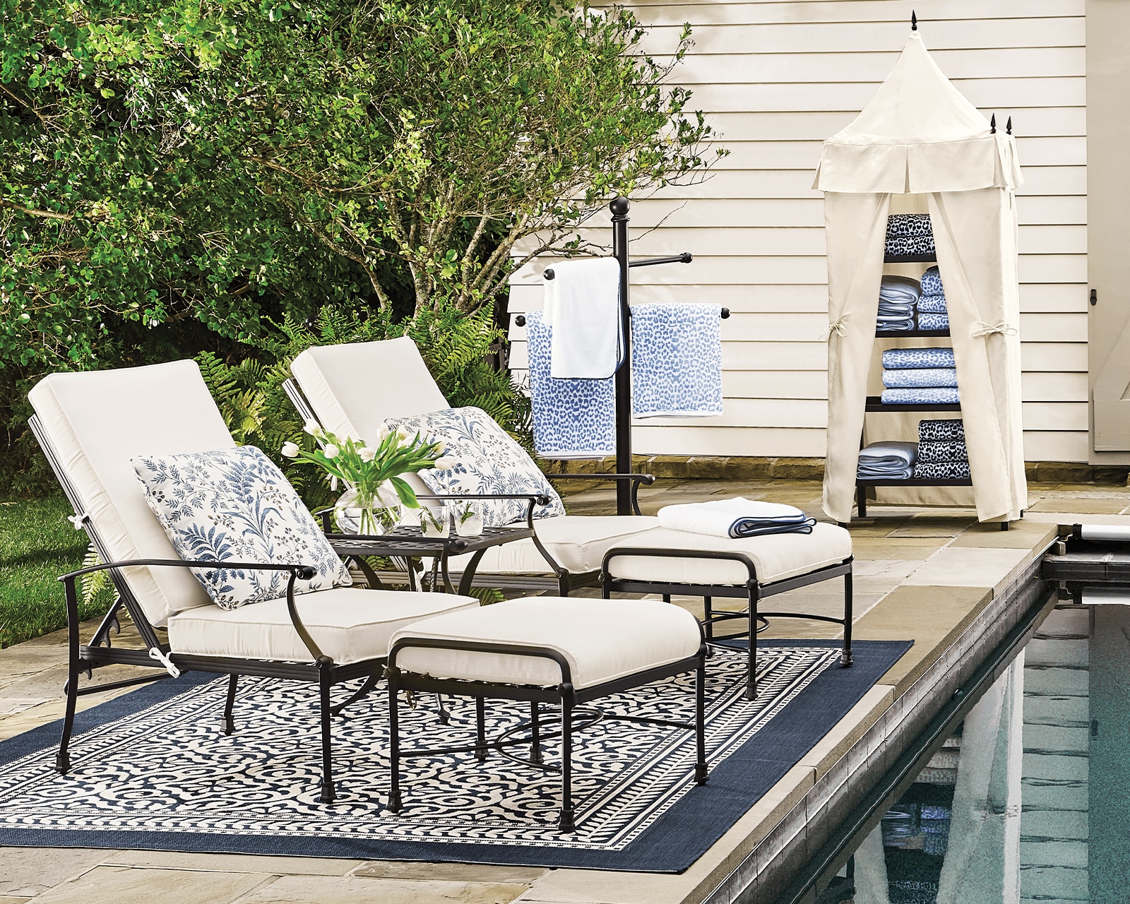 Two chaise lounge chairs beside an outdoor pool