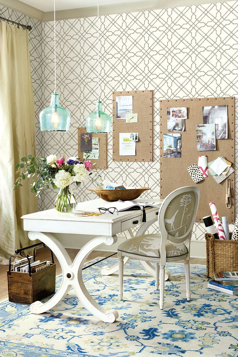 Home office with patterned rug and wallpaper in blues and beige