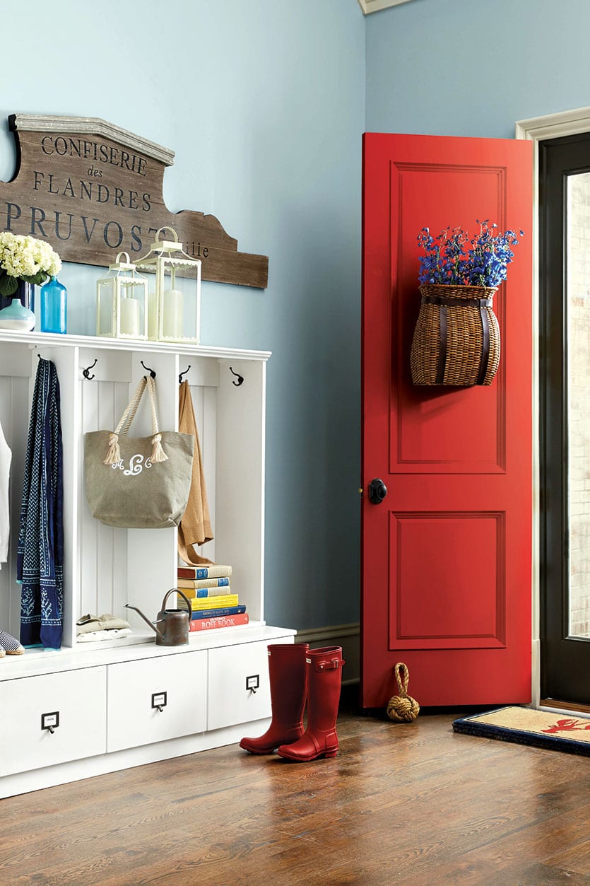 Entryway with mudroom built-in cabinets and red front door