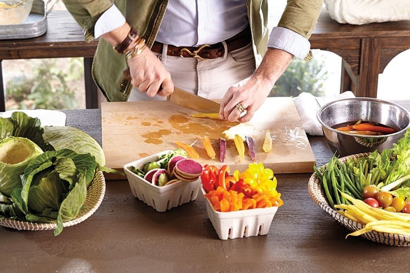 Prep veggies for your crudité platter by cleaning and slicing them into bite sized pieces