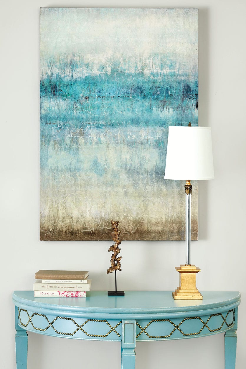 A watery blue abstract art piece feels beachy in a sophisticated way