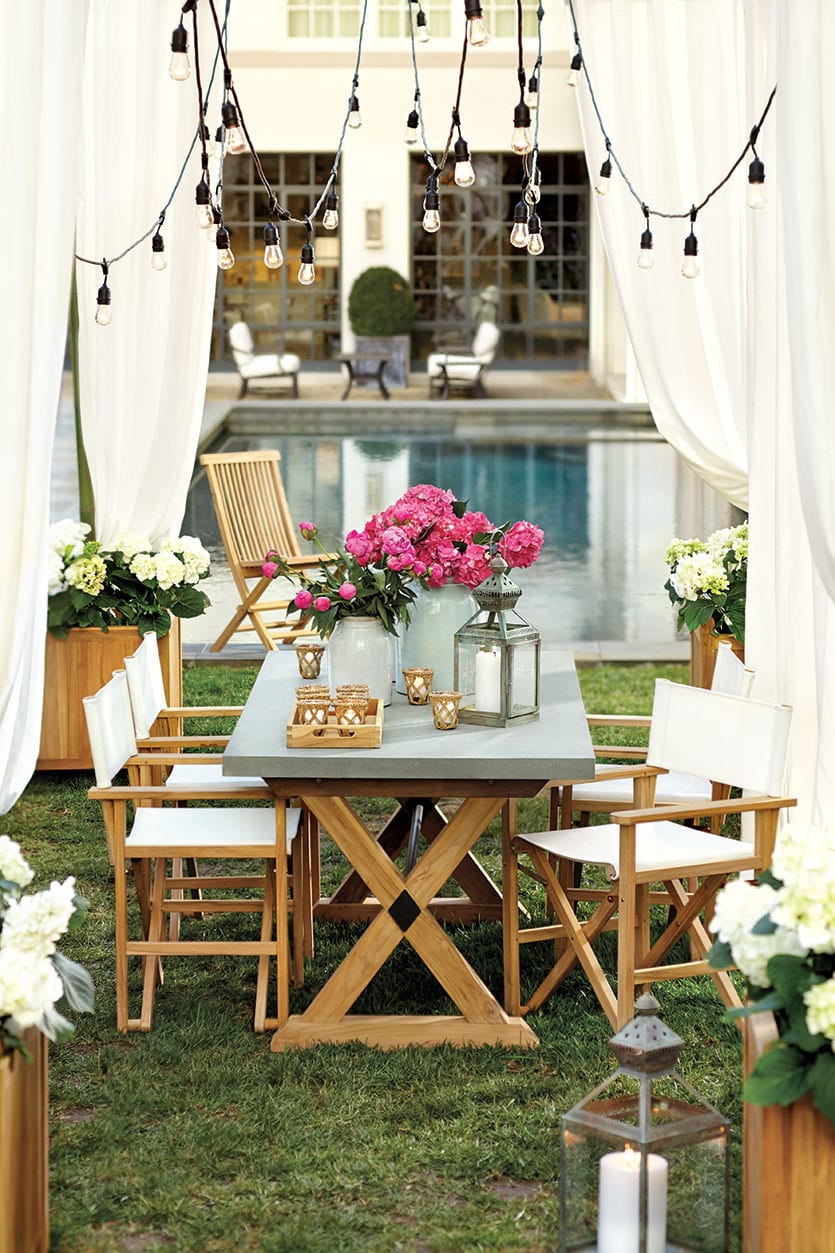 Suzanne Kasler's Orleans Outdoor Collection with white outdoor drapery panels and pink peonies