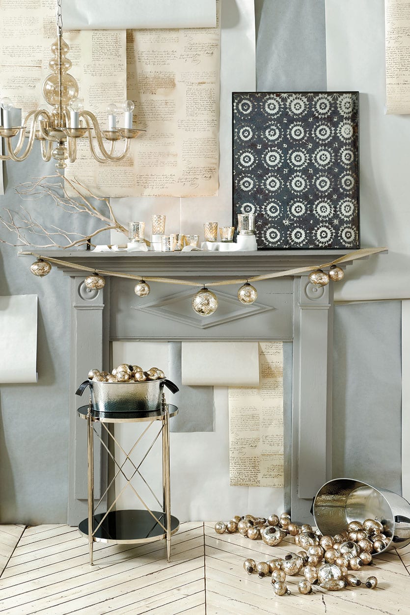 A garland of ornaments make this fireplace mantel shine