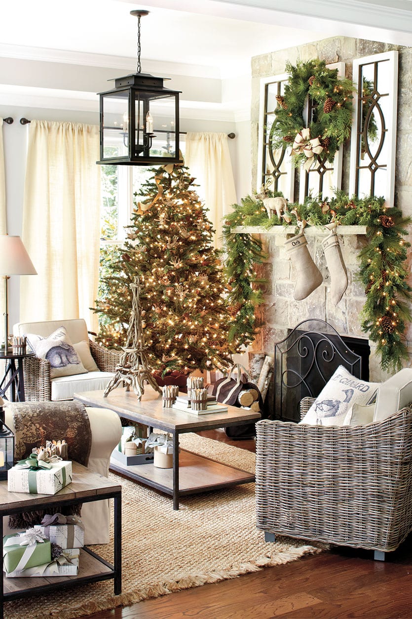 Garland, a wreath, and stockings by the fireplace mantel