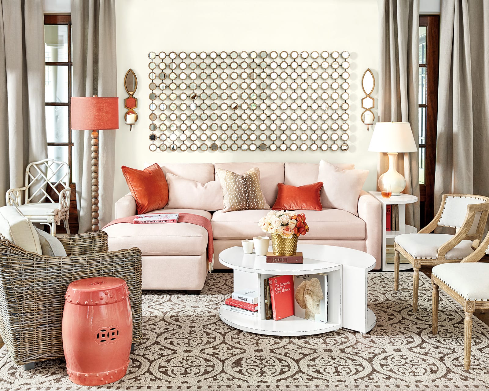 Blush pink linen sofa with bright orange velvet