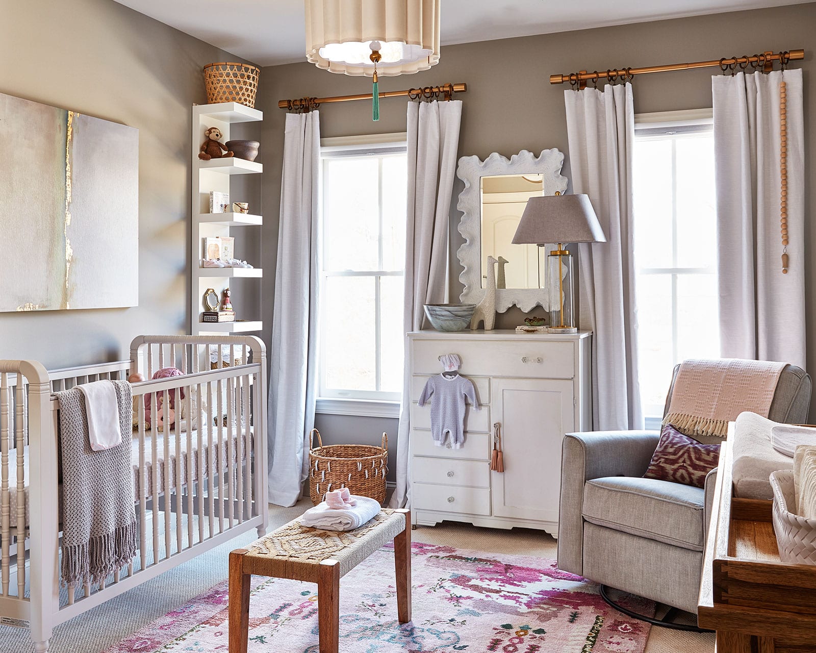 Natalie's soon-to-be newborn Camille's nursery has a bold rug and pink accents