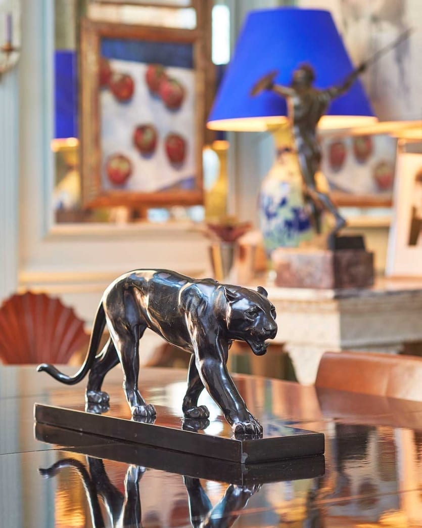 A panther statue acts as a permanent centerpiece on Miles' dining room table