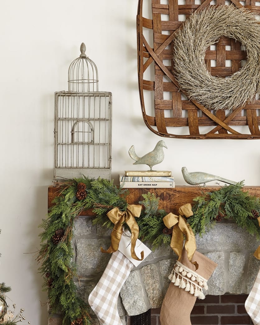 A neutral inspired Christmas mantel with layered pieces and texture