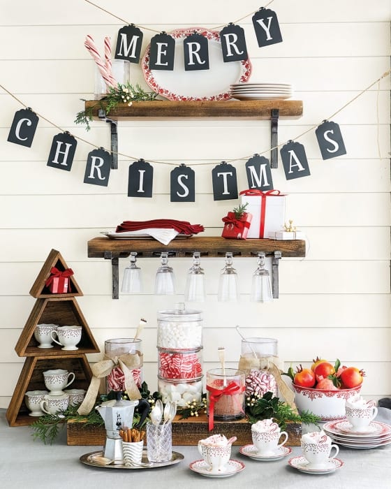 Hot cocoa bar with hanging 'Merry Christmas' tags and hot chocolate fixings