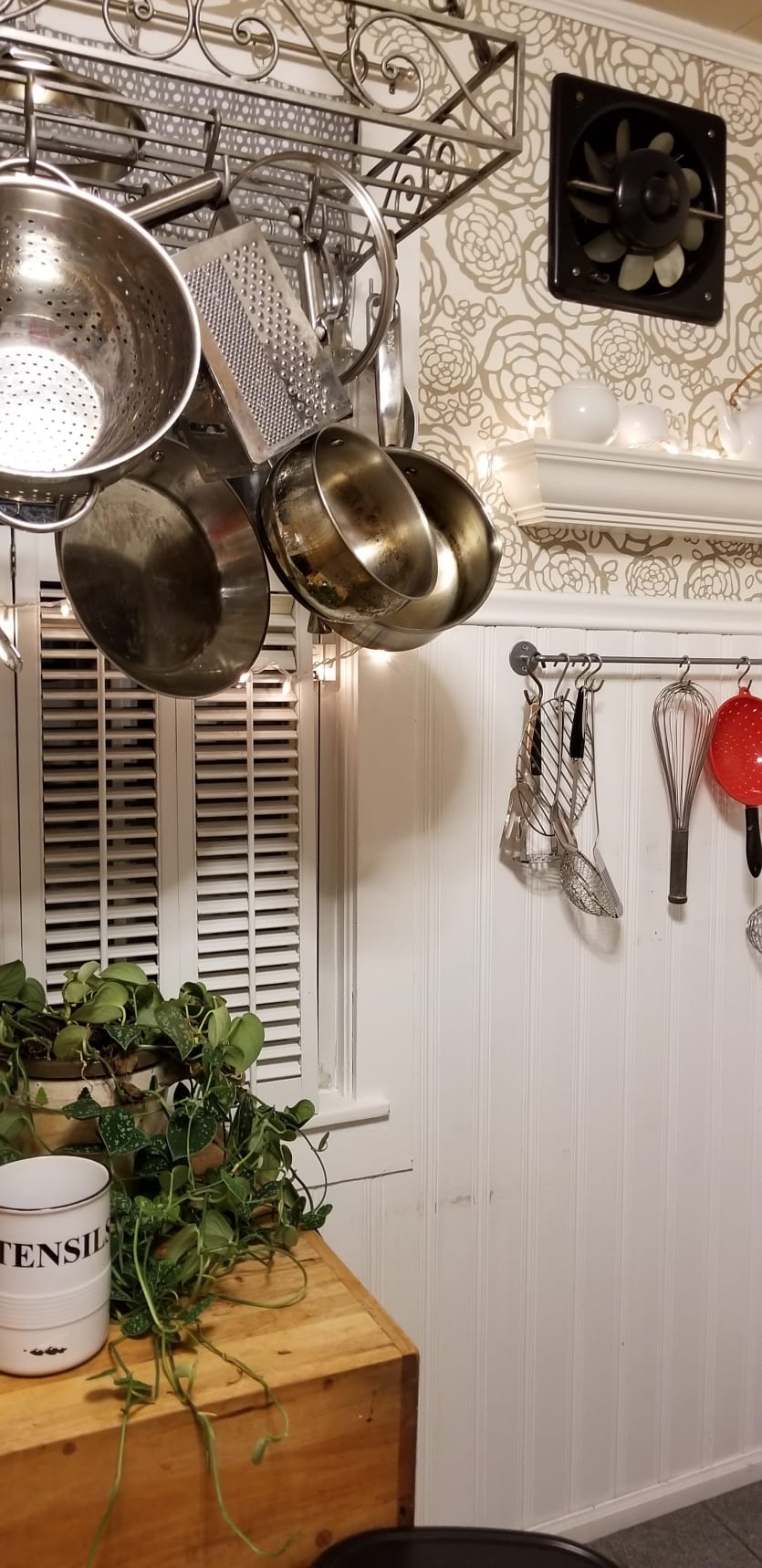 White wainscoting and metallic floral wallpaper in a kitchen