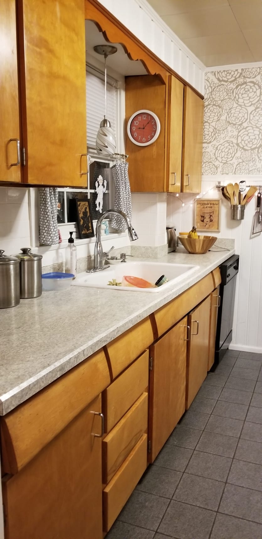 Kitchen with oak cabinets and metallic wallpaper