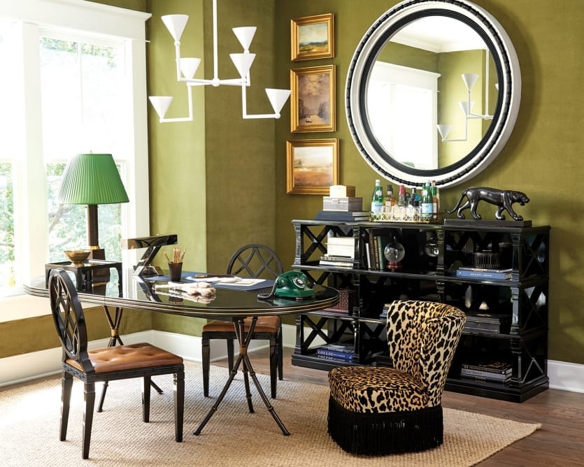 Dining room and office space designed by Miles Redd with green velvet upholstered walls and black lacquer furniture