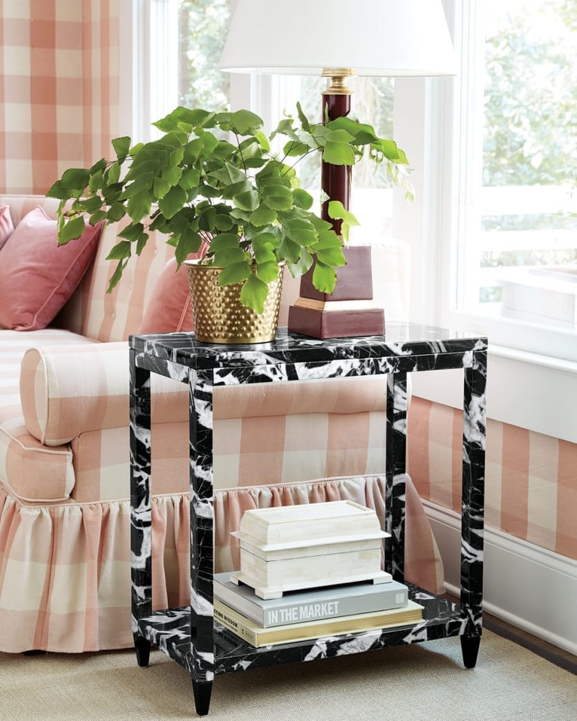 Miles Redd's Faux Marble Side Table next to a sofa in pink and white buffalo check