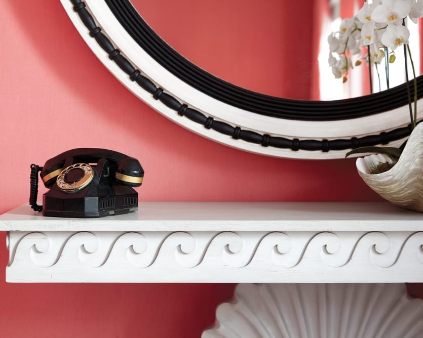 Vintage phone propped on a console table from Miles Redd's collection