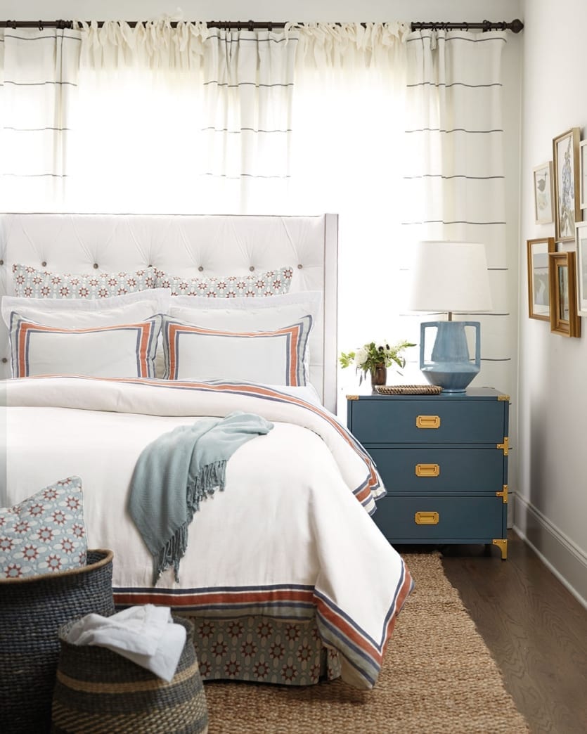 Blue and white bedroom with blue and orange bedding