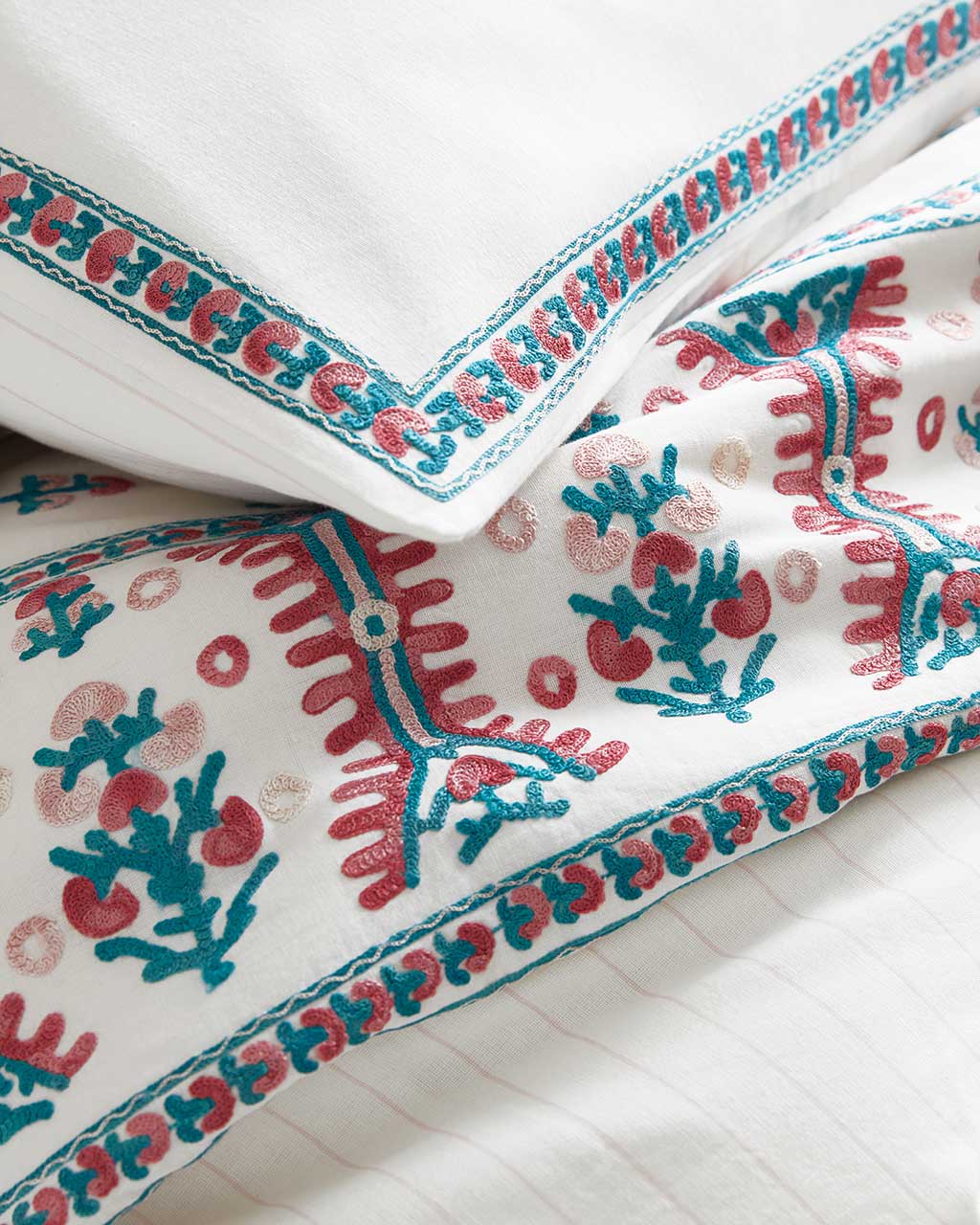 Pink and blue embroidered bedding designed by Suzanne Kasler for Ballard Designs