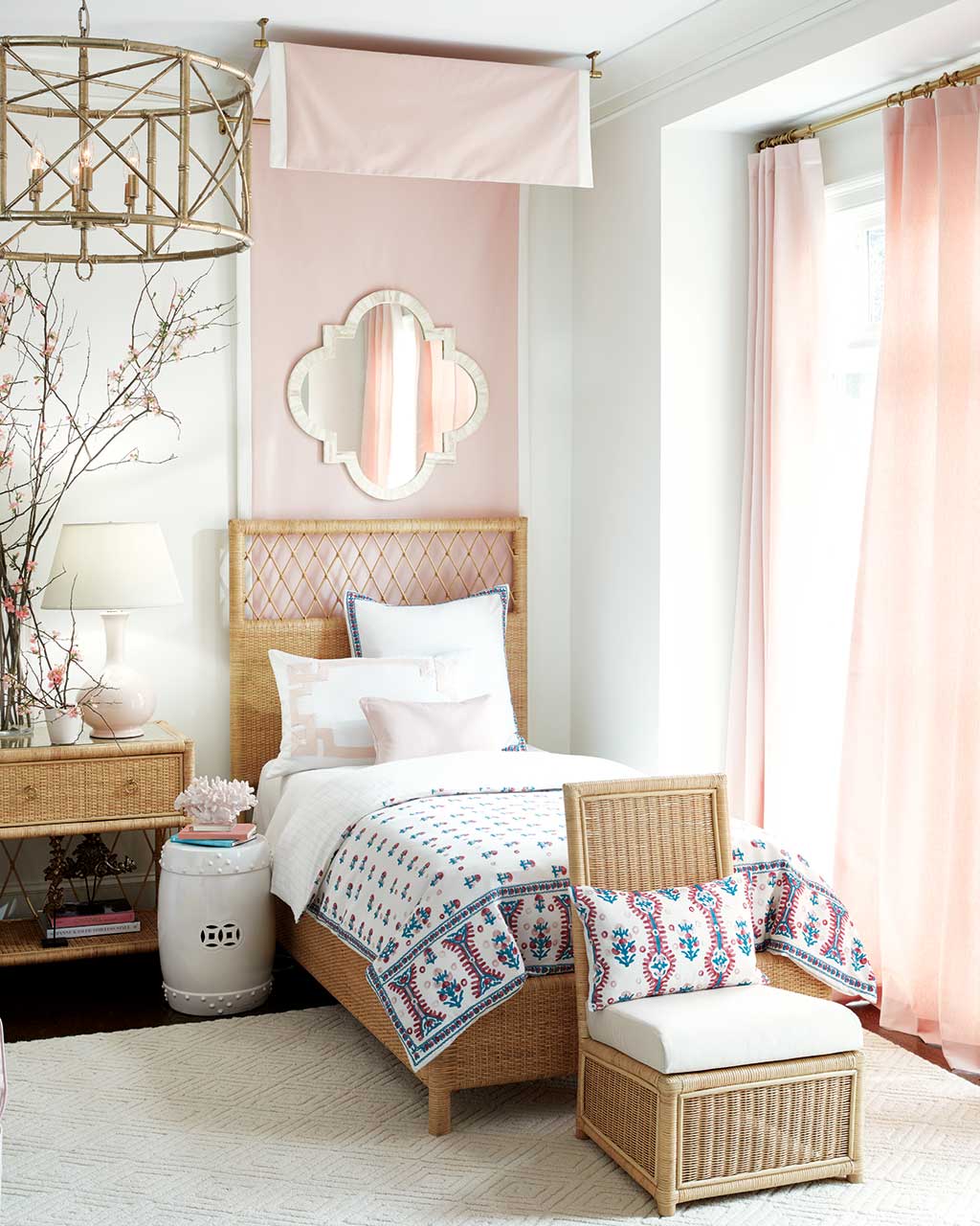 Blush pink bedroom with wicker bed designed by Suzanne Kasler for Ballard Designs