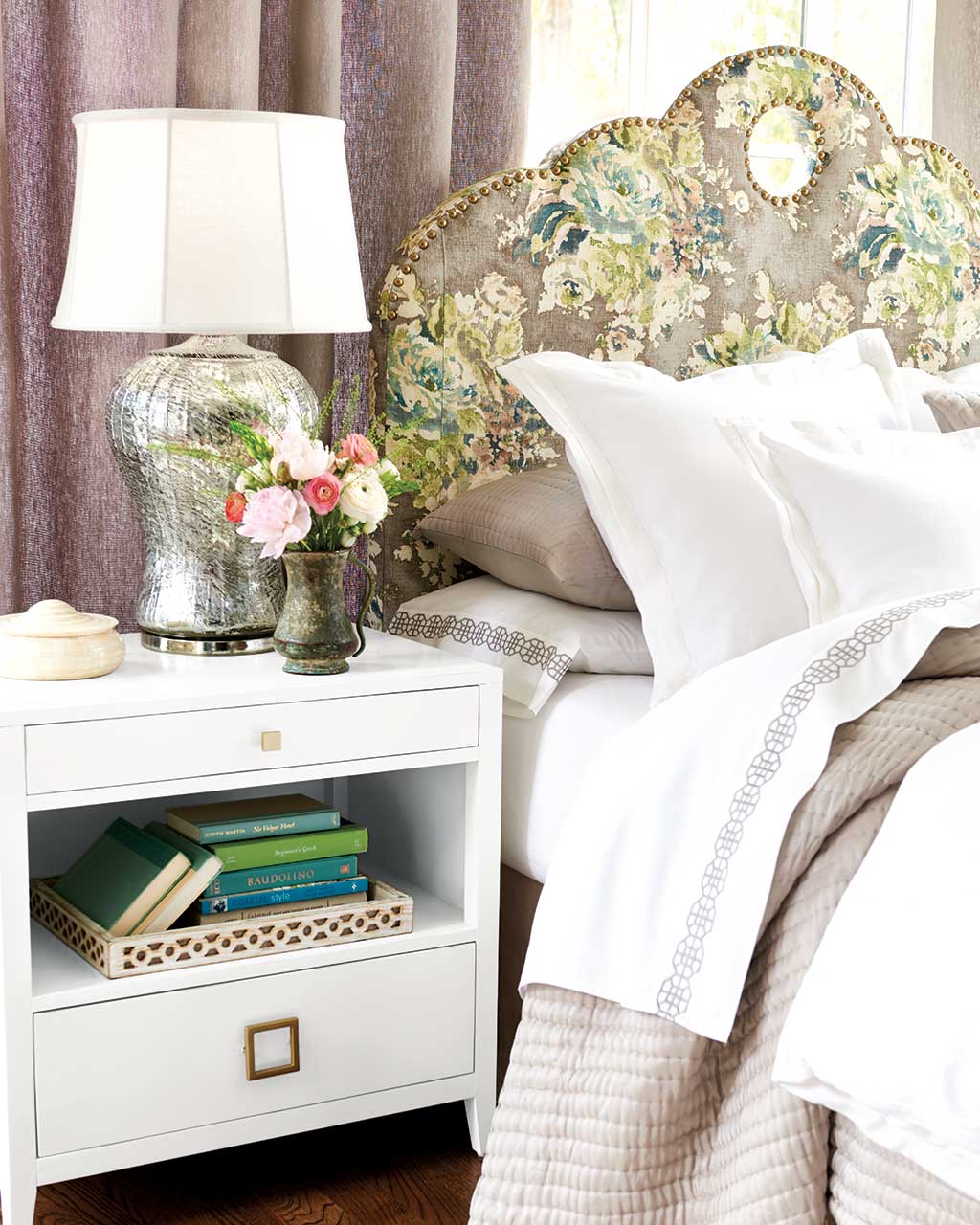 A floral print headboard draws attention in this bedroom | Ballard Designs