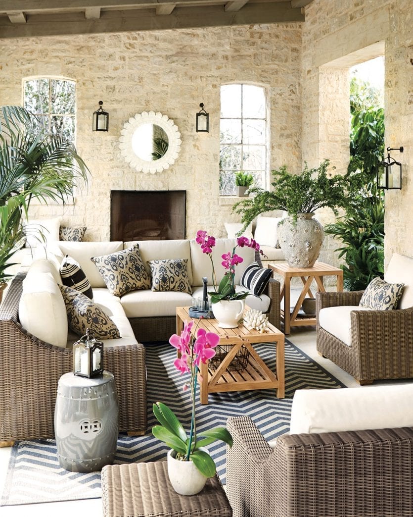 Woven outdoor sectional on covered patio and porch with black and white accents