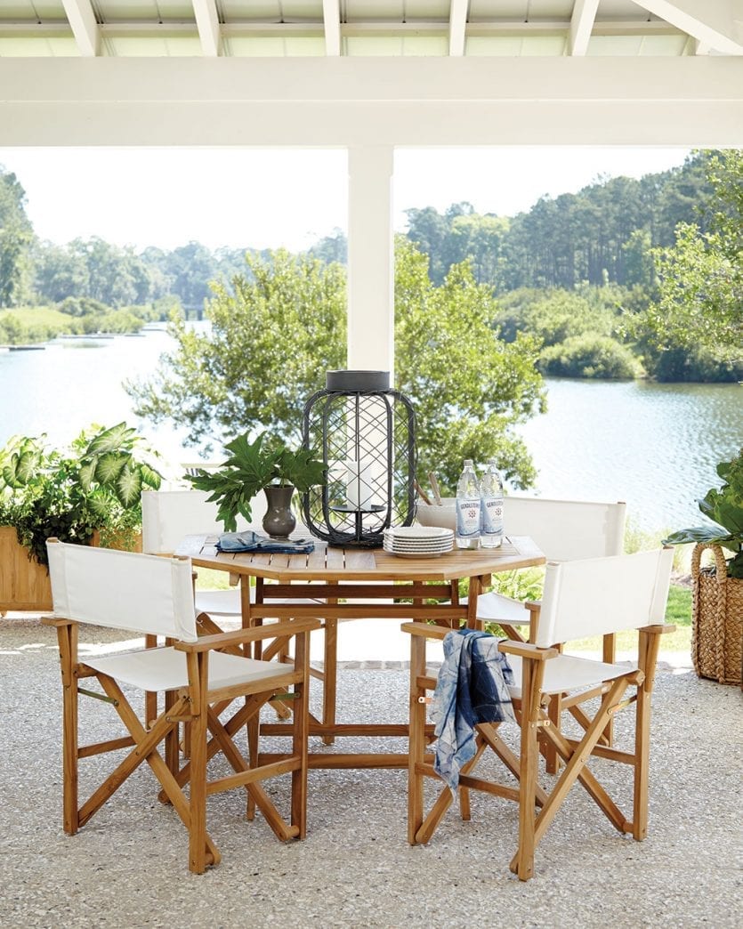 Patio space with neutral color palette overlooking a lake