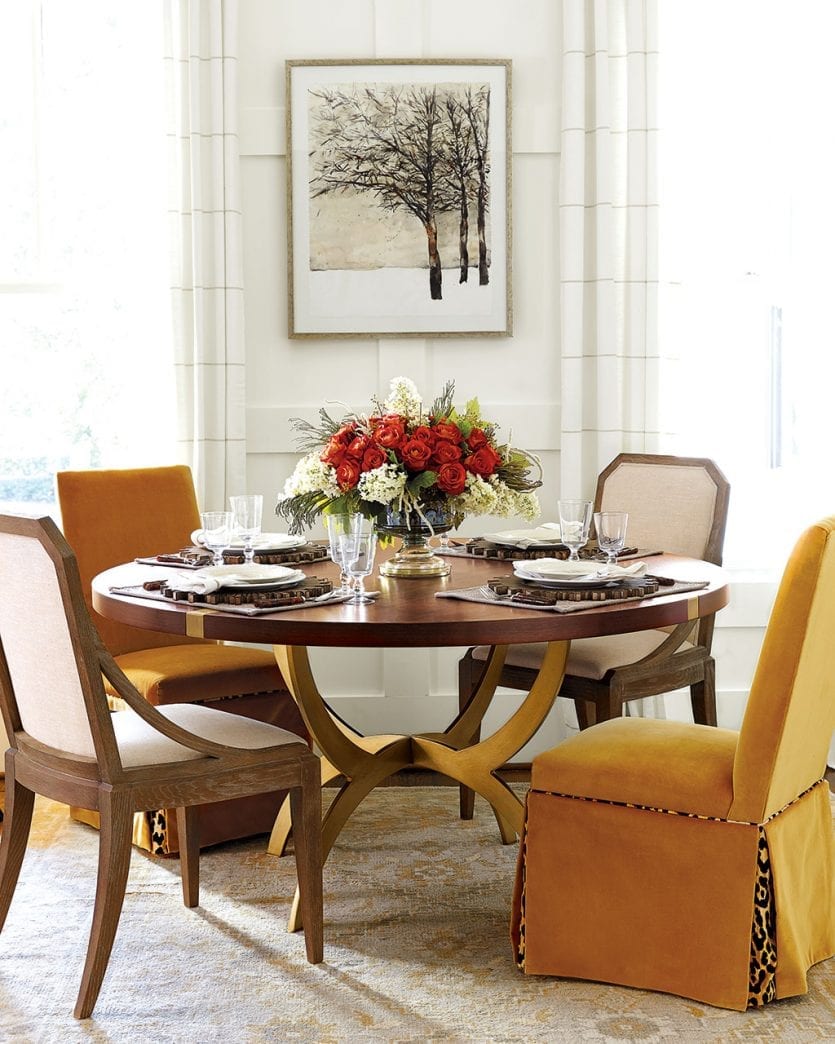 Topaz gold velvet chairs accented by gold base dining table