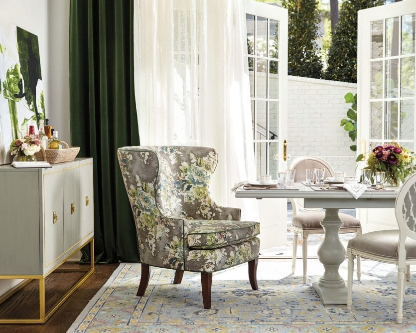 Emerald green velvet drapes accent in neutral dining room