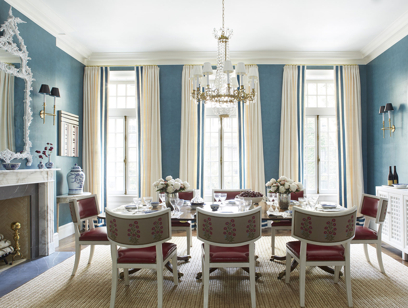 Dining Room with leather dining chairs, blue walls, and a crystal chandelier