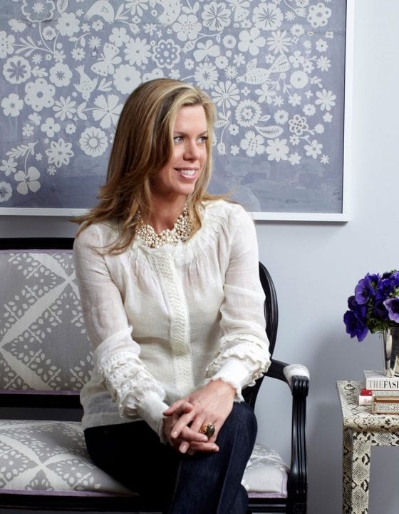 New York interior designer Ashley Whittaker sitting on a settee