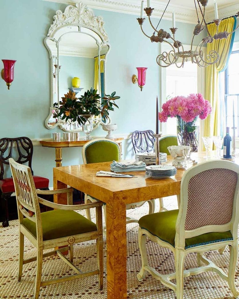 Dining room with burlwood dining table, ice blue walls, and chartreuse velvet chairs