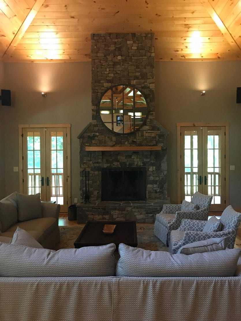 Living room in Ryan's lake cabin with antique mirror over the fireplace