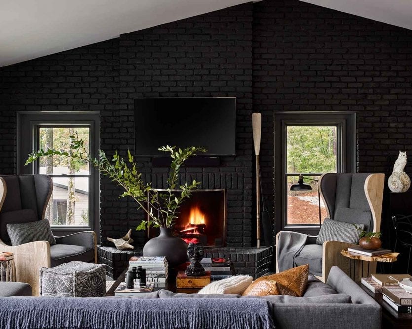 Black painted living room in Matthew Quinn and Ric Parrish's lake house