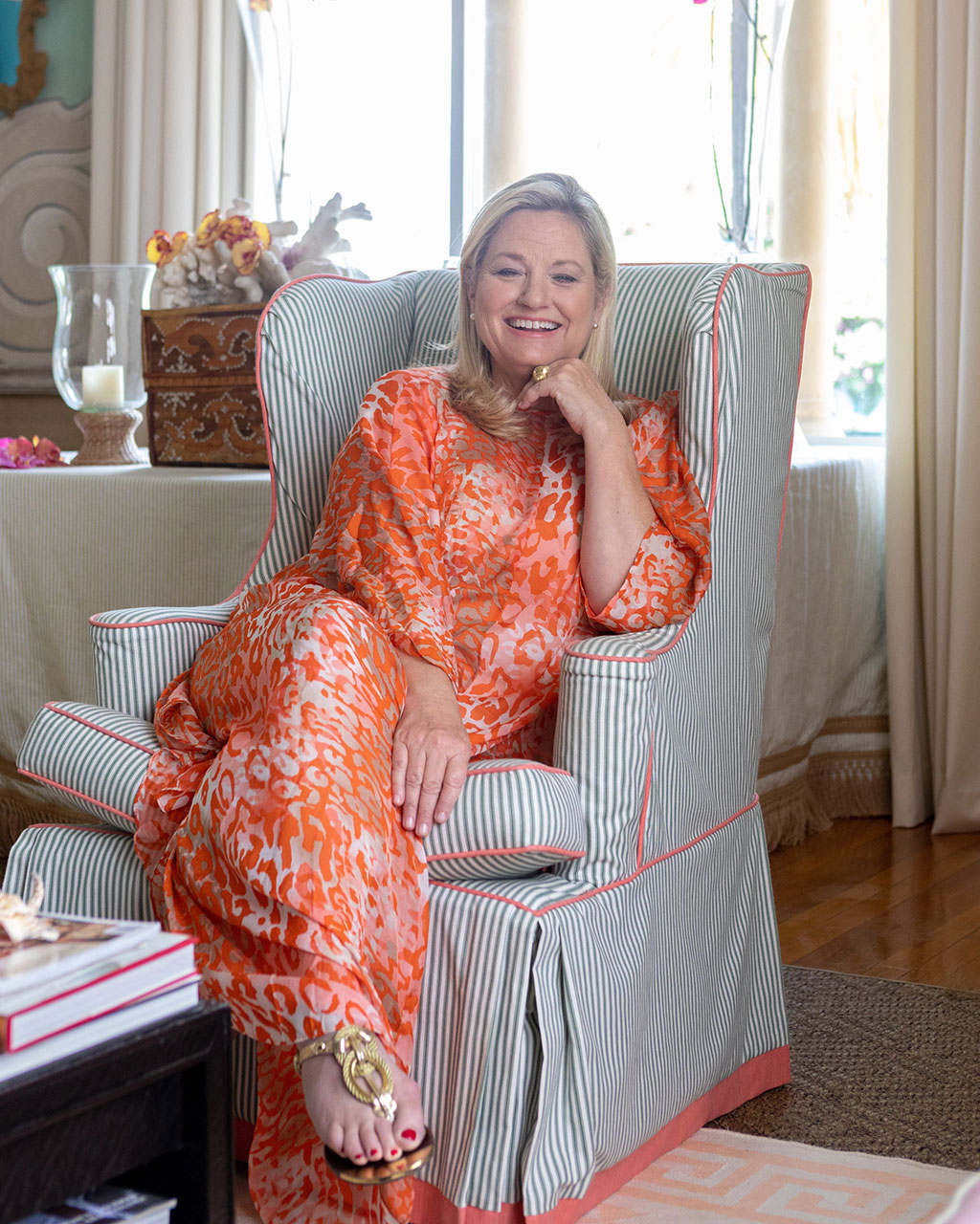 Interior designer Amanda Lindroth in a blue and white striped wingback chair