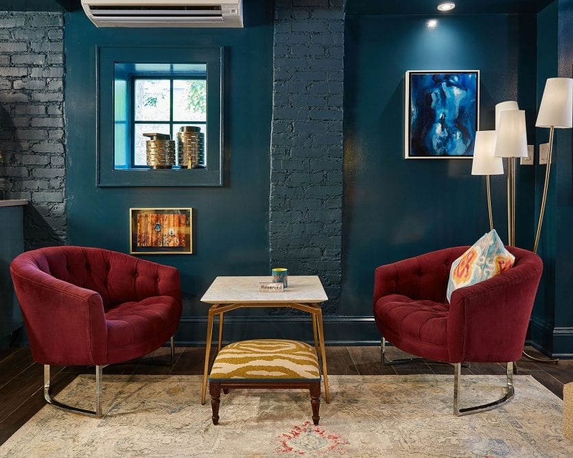 Purple chairs in Peacock blue basement turned lounge at podcast host Karen Mooney's house