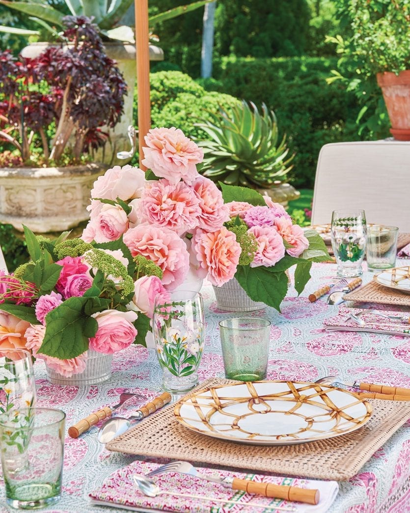 Pink table with bamboo accents and carnation flower arrangements