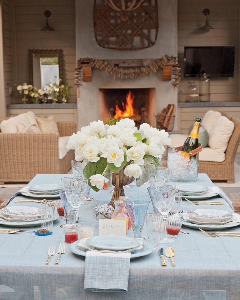 Outdoor table setting with white peonies as centerpiece