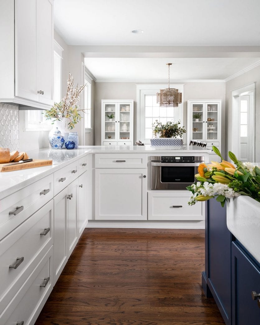 Family kitchen with navy island designed by Kimberly Barr