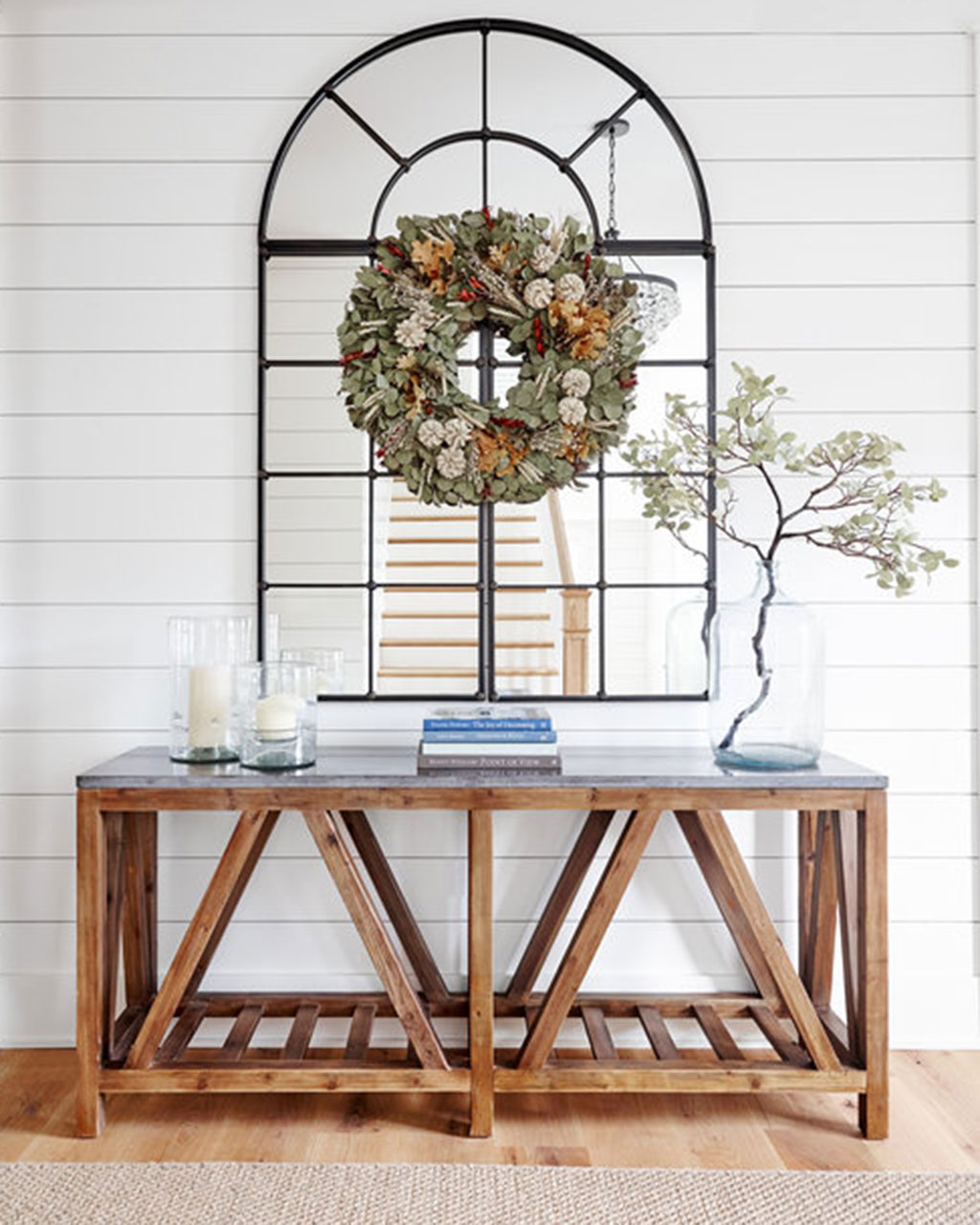 Entryway with large mirror and organic wreath