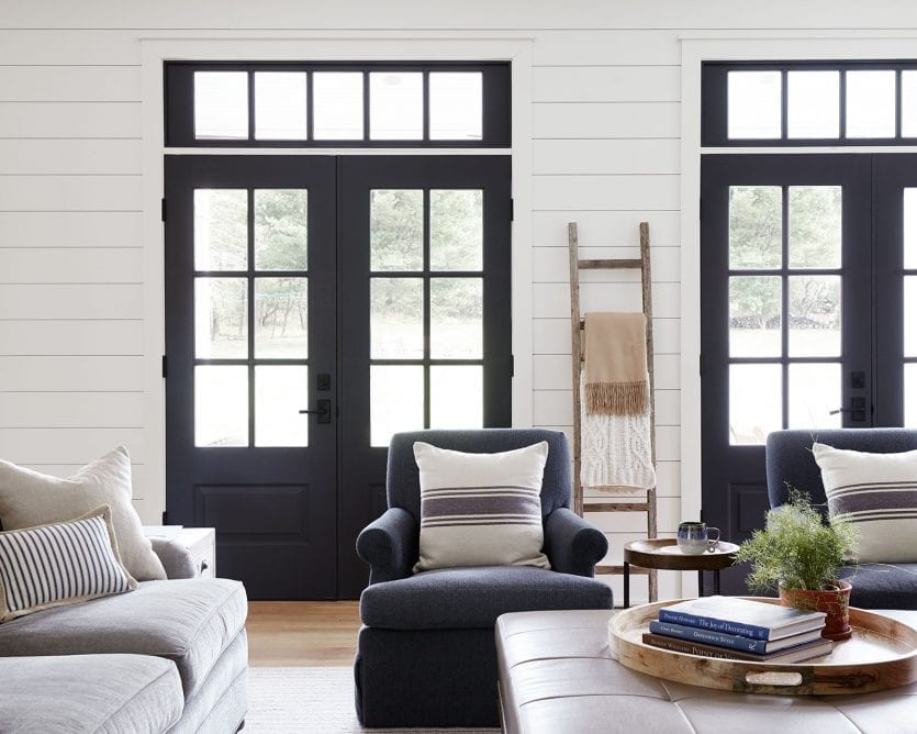 Family room with dark windows and upholstered chairs