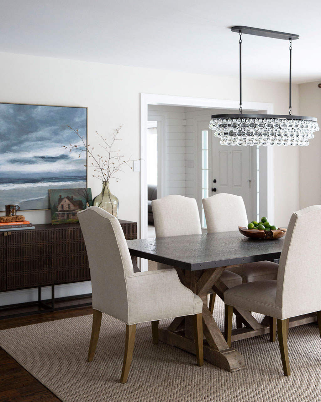 Classic dining with upholstered chairs and a crystal chandelier