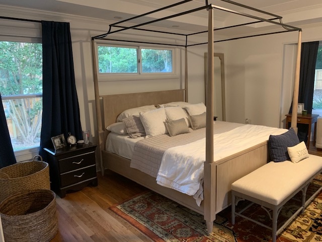 Washed oak poster bed with canopy in bedroom