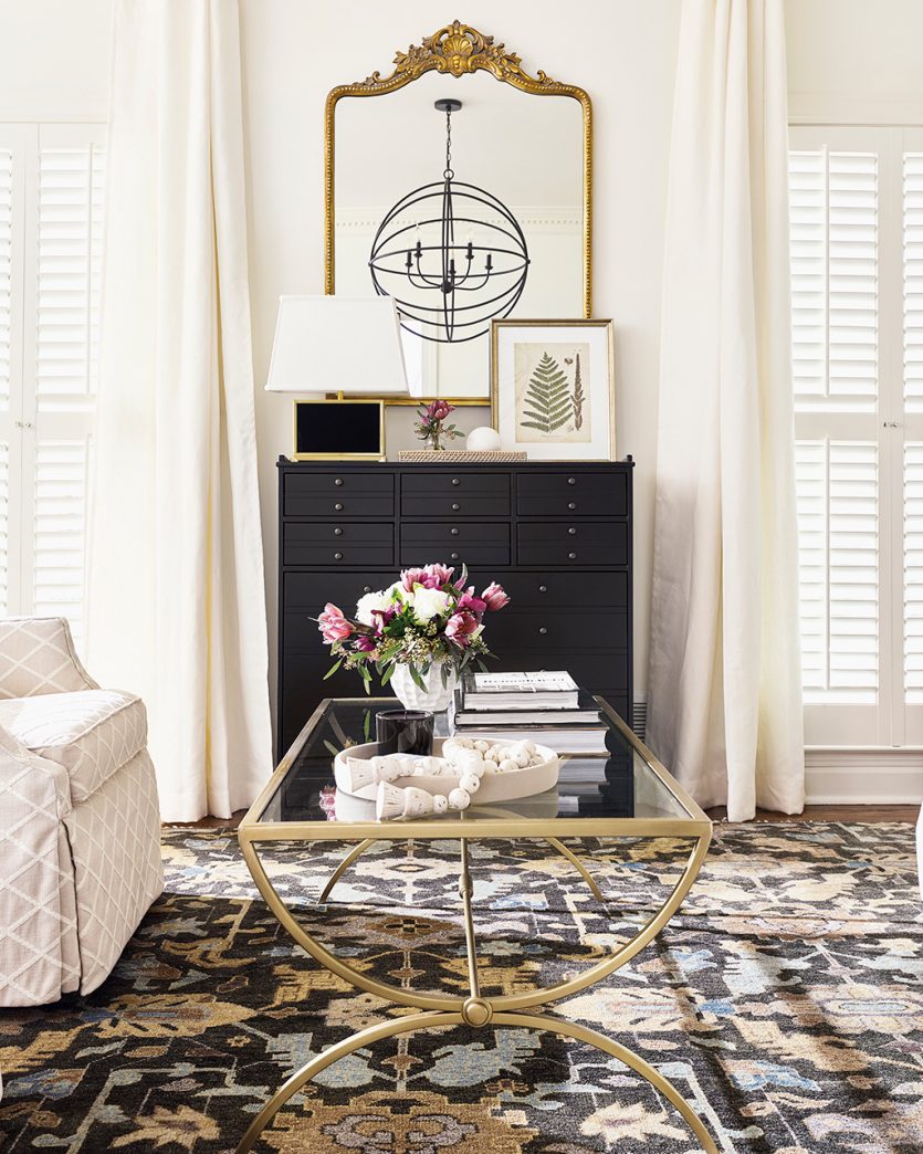 Black and white living room with handmade rug designed by Ballard Designs