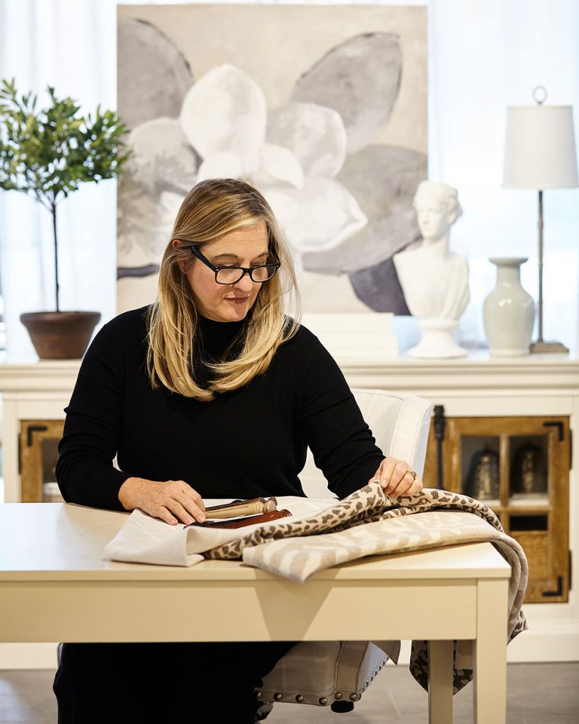 Skye Kirby Westcott at a desk working with fabric swatches