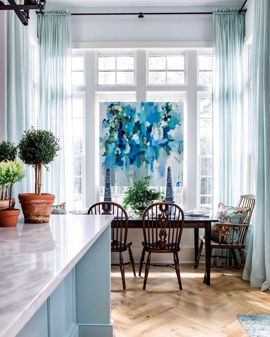 Kitchen and breakfast nook with light blue color palette designed by Jena Salmon