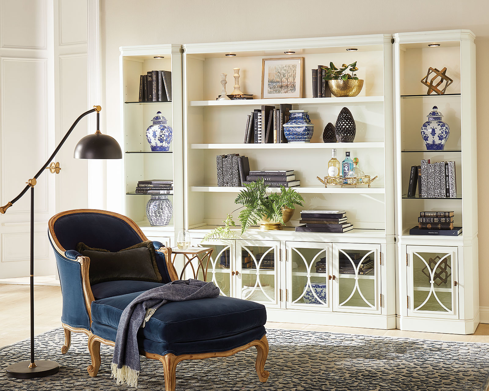 Carve out another room with a chaise lounge, floor lamp and bookshelf